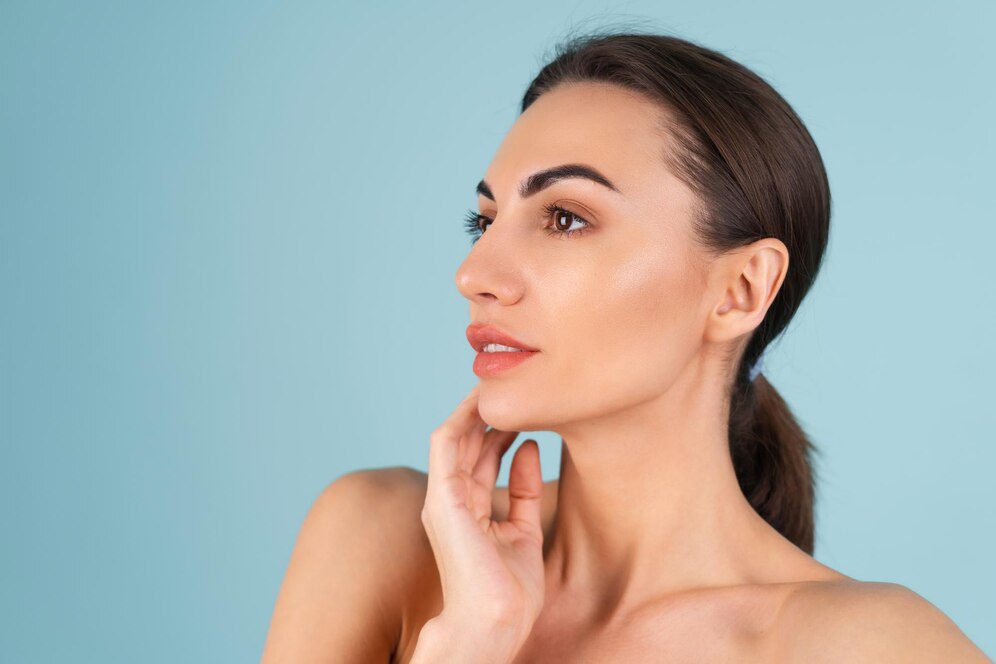 close-beauty-portrait-topless-woman-with-perfect-skin-natural-make-up-plump-nude-lips-blue-background